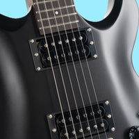 Close up view of Cort M200 Electric Guitar Black Matte on blue background