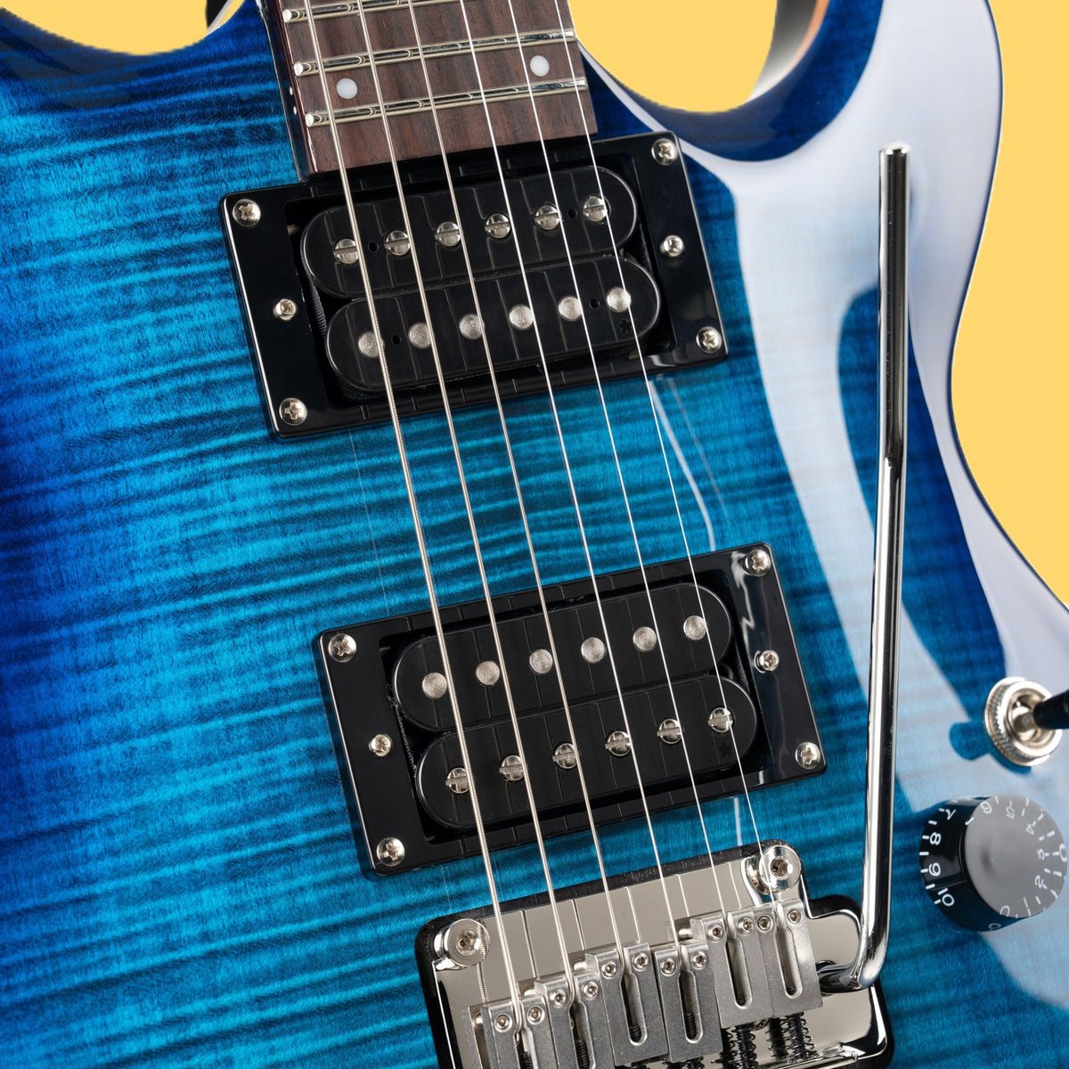 Close up view of Cort M600T Electric Guitar Blue Burst on yellow background