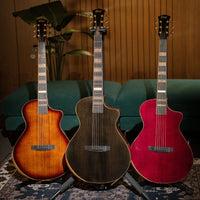 Front view of Cort Masterpiece Series Modern Acoustic Electric Guitar Black, Burst, and Burgundy in living room