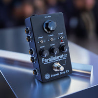 Cosmic Loop FX Parallelarator effects pedal on a reflective surface with a blurred background