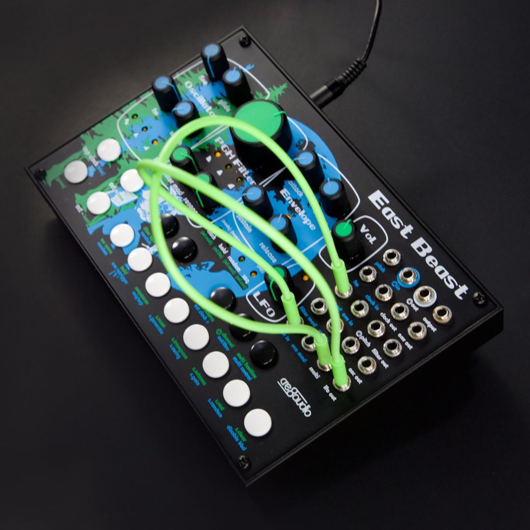 Electronic music synthesizer with green cables on a black background