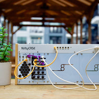 Electronic device with cables on a wooden surface, blurred background