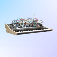 Synthesizer with visible wiring on a light blue background
