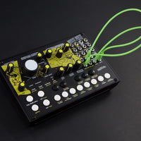 Black electronic device with yellow and white components on a dark background