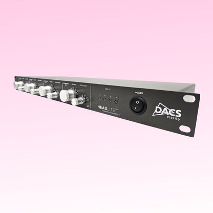 Close up of front panel of DACS Audio HeadLite 4 on pink background