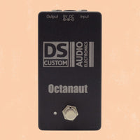 Front view of DS Custom Octanaut Octave Up Pedal on orange background