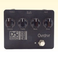 Front view of DS Custom Ovrdrvr Pedal on yellow background