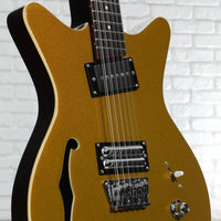 Close up view of Danelectro Fifty Niner 12-String Semi Hollow Electric Guitar Gold on white brickwall
