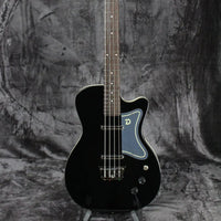 Close up front view of Danelectro '56 Bass Guitar (Black) on black velvet background