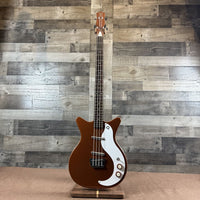 Front view of Danelectro '59DC Short-Scale Bass Guitar Copper on wooden floor and wooden wall background