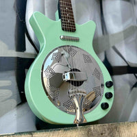 Close up view of Danelectro '59 Resonator Electric Guitar Vintage Aqua leaning on graffiti painted wall