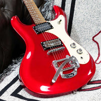 Close up view of Danelectro '64 Electric Guitar Red Metallic on couch with gray cover