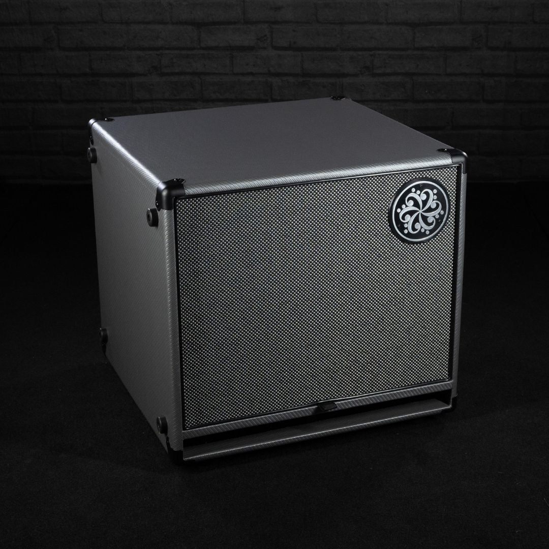 Angled front view of Darkglass 112 Bass Cabinet on grey brickwall background