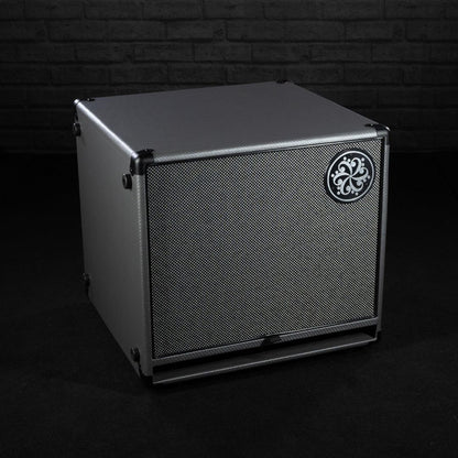Angled front view of Darkglass 112 Bass Cabinet on grey brickwall background