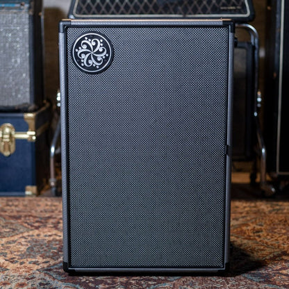 Front view of Darkglass 210 Bass Cabinet upright on carpet in studio