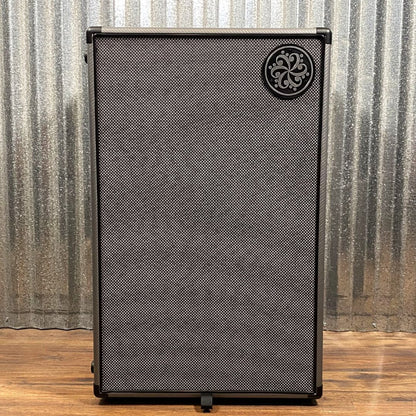 Front view of Darkglass 212 Bass Cabinet on wooden floor with grey metal background