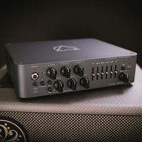 Angled front view of Darkglass Alpha-Omega 900 Bass Amplifier Head on top of speaker cab