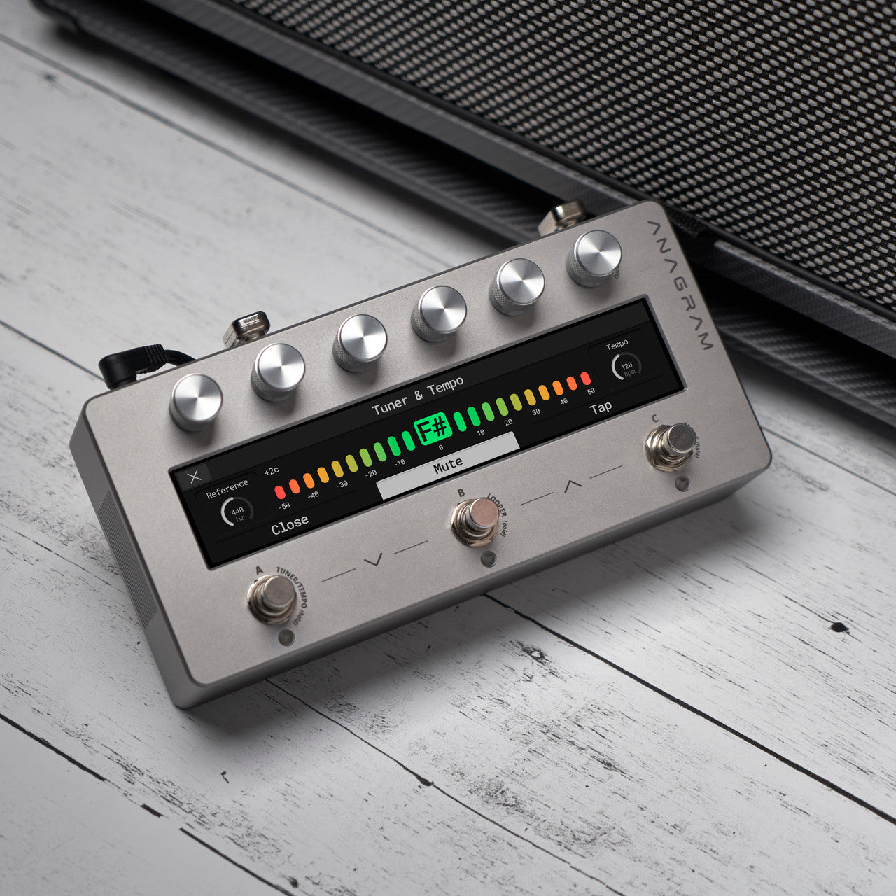 Angled view of Darkglass Anagram Pedal on grey wooden surface