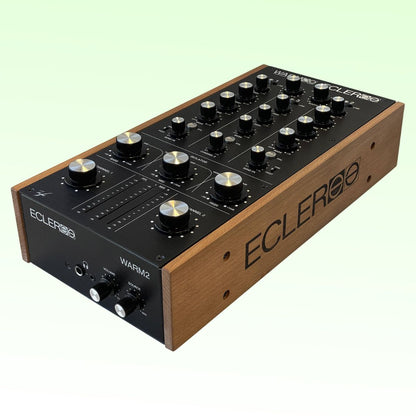 Angled view of Ecler WARM2 Professional 2-Channel Analog Rotary DJ Mixer on green background