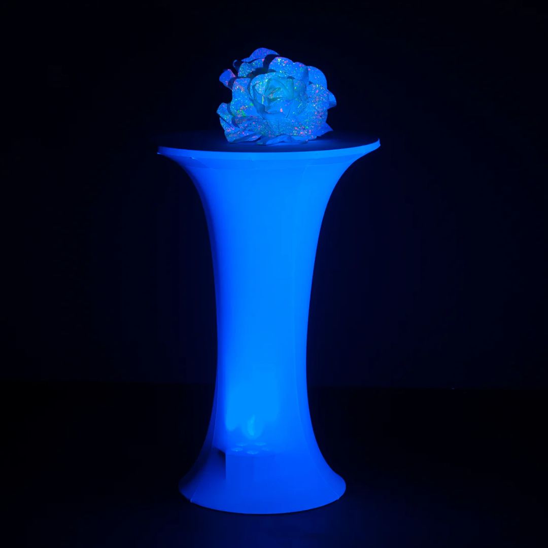 Front view of Eliminator Lighting Decor Cocktail Table with Scrim with ornament on top in dim venue