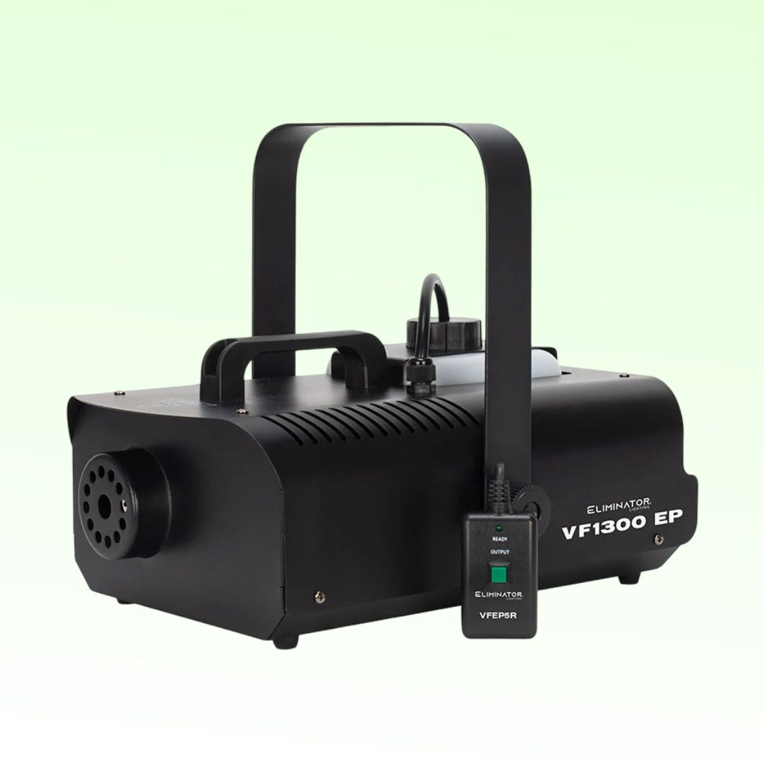 Angled view of Eliminator Lighting VF1300 EP Wireless Fog Machine with remote on green background
