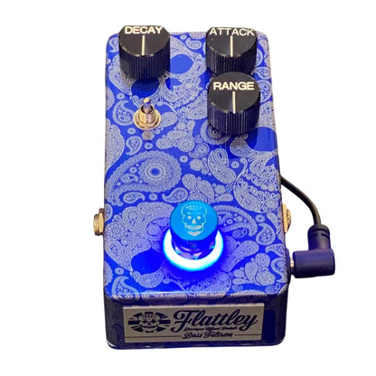 Angled front view of Flattley Bass Filtron Bass Envelope Filter Pedal with power cable attached on white background