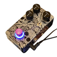 Angled top view of Flattley Revolution Dynamic Overdrive Pedal while attached to power cord on white background