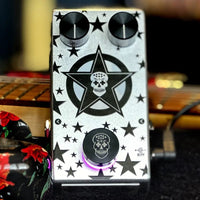 Top view of Flattley Star Fazer Phaser Pedal on top of guitar on black surface