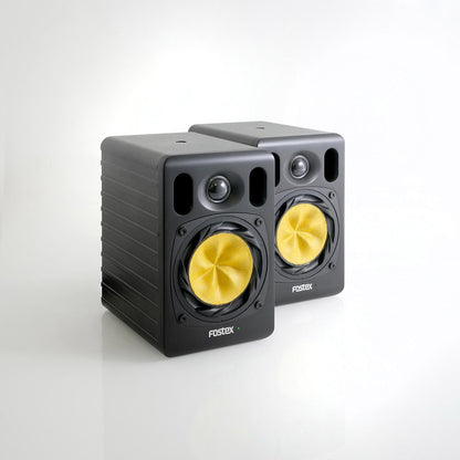 Angled view of Fostex NF04R 4" Active Speaker Pair on grey background