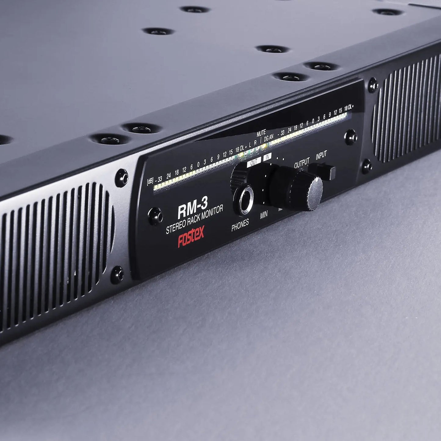 Close up angled view of Fostex RM-3 Stereo Rack Monitor on grey surface