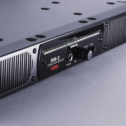 Close up angled view of Fostex RM-3 Stereo Rack Monitor on grey surface