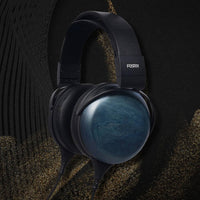 Angled view of Fostex TH1000RPmk2 Premium Headphones on black with beige accent background