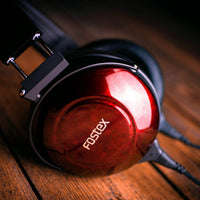 Close up angled view of Fostex TH900mk2 Premium Headphones w/ Headphone Stand on wooden surface