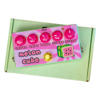 Front view of FruitFX Melon Cube Pedal on top of green box with white background