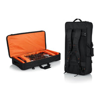 Black and orange case with equipment and a matching black backpack on a white background