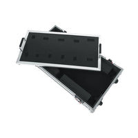 Black flight case with a pedalboard on a white background