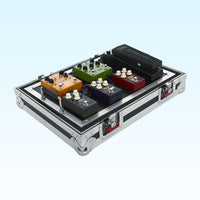 Guitar effect pedals in a metal case on a light blue background