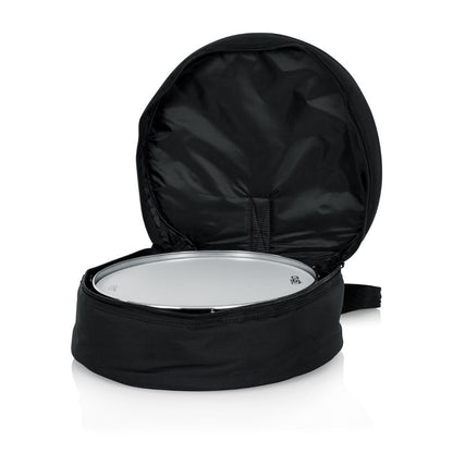 Black drum bag with a silver drum inside on a white background