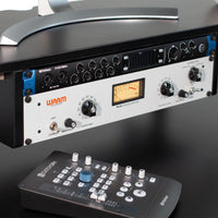 Audio mixing console with control panel on a dark surface