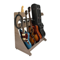 Guitar stand holding multiple guitars and cases on a white background