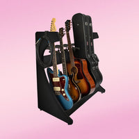 Guitar stand holding multiple guitars against a pink background