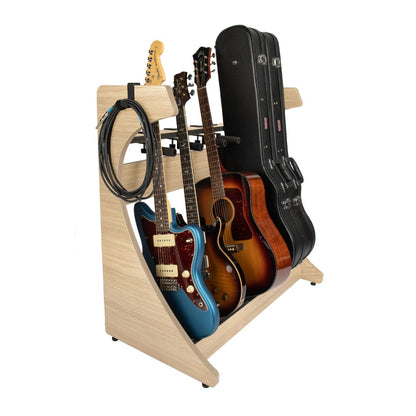 Guitar stand holding multiple guitars and cases on a white background