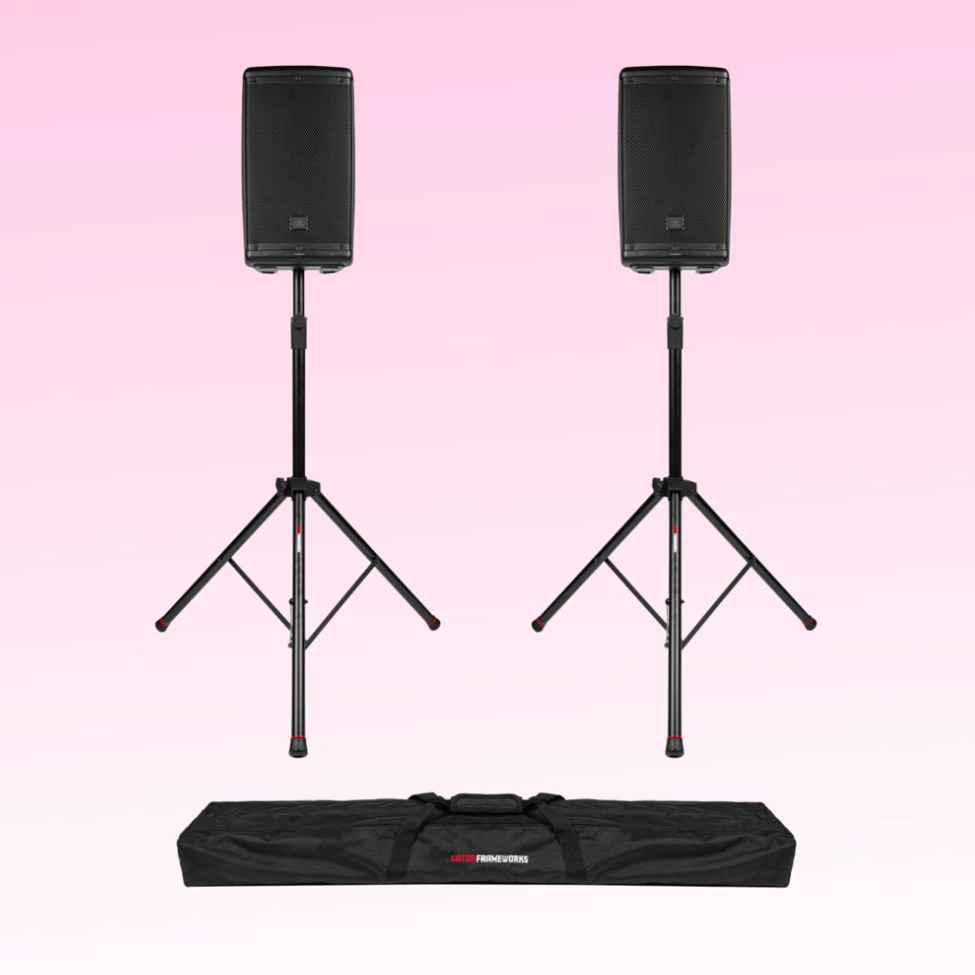 Two black speakers on stands with a carrying bag on a pink background