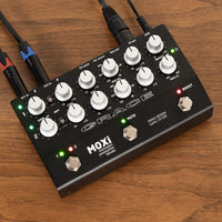 Angled top view of Grace Design MOXi Pedal with cables attached on wooden surface