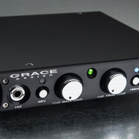Close up front view of Grace Design m101 Single Channel Mic Preamplifier on gray surface