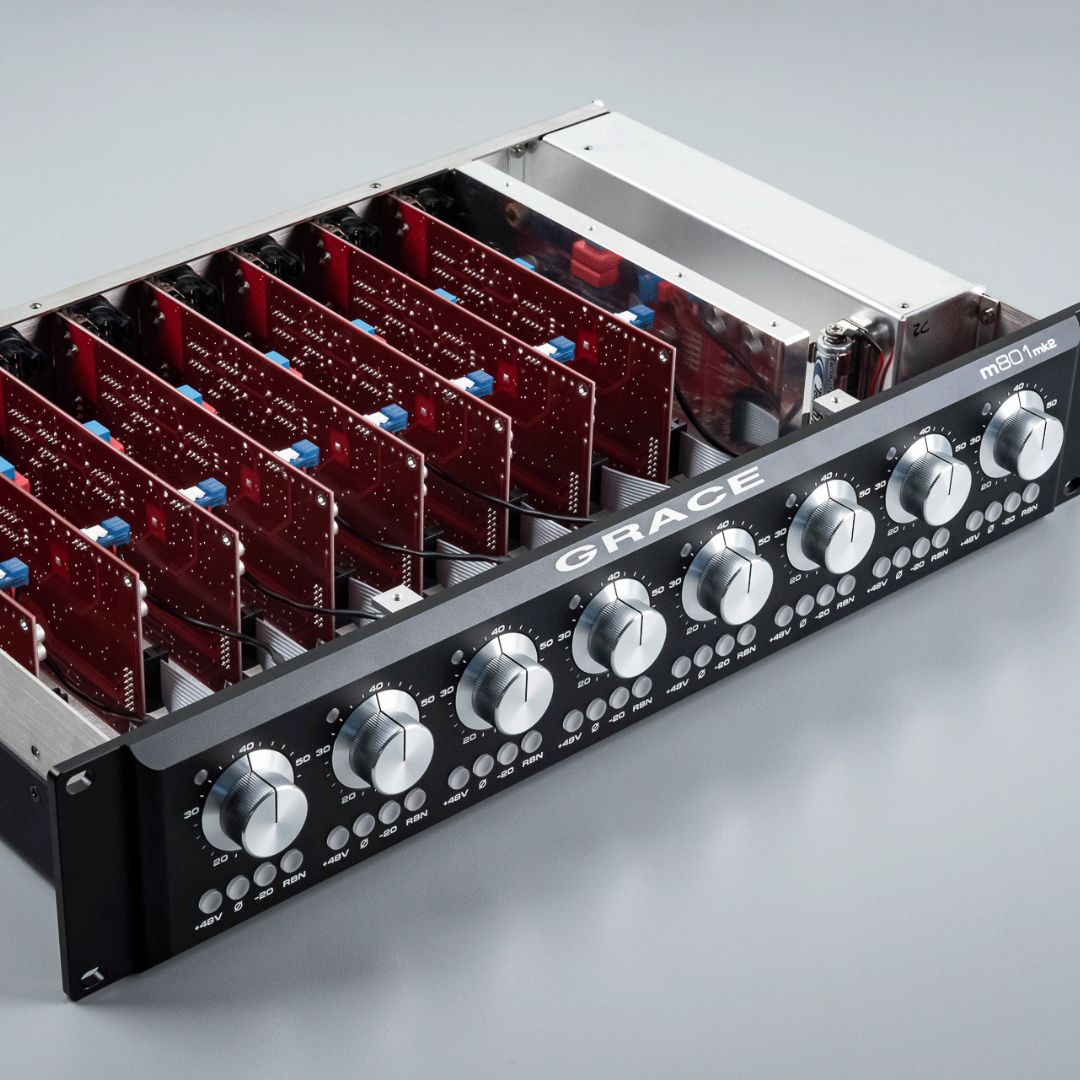 Angled view of Grace Design m801mk2 8-Channel Microphone Preamp with top removed on grey surface