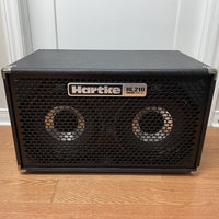 Hartke HL210 bass guitar amplifier on a wooden floor with a white wall background