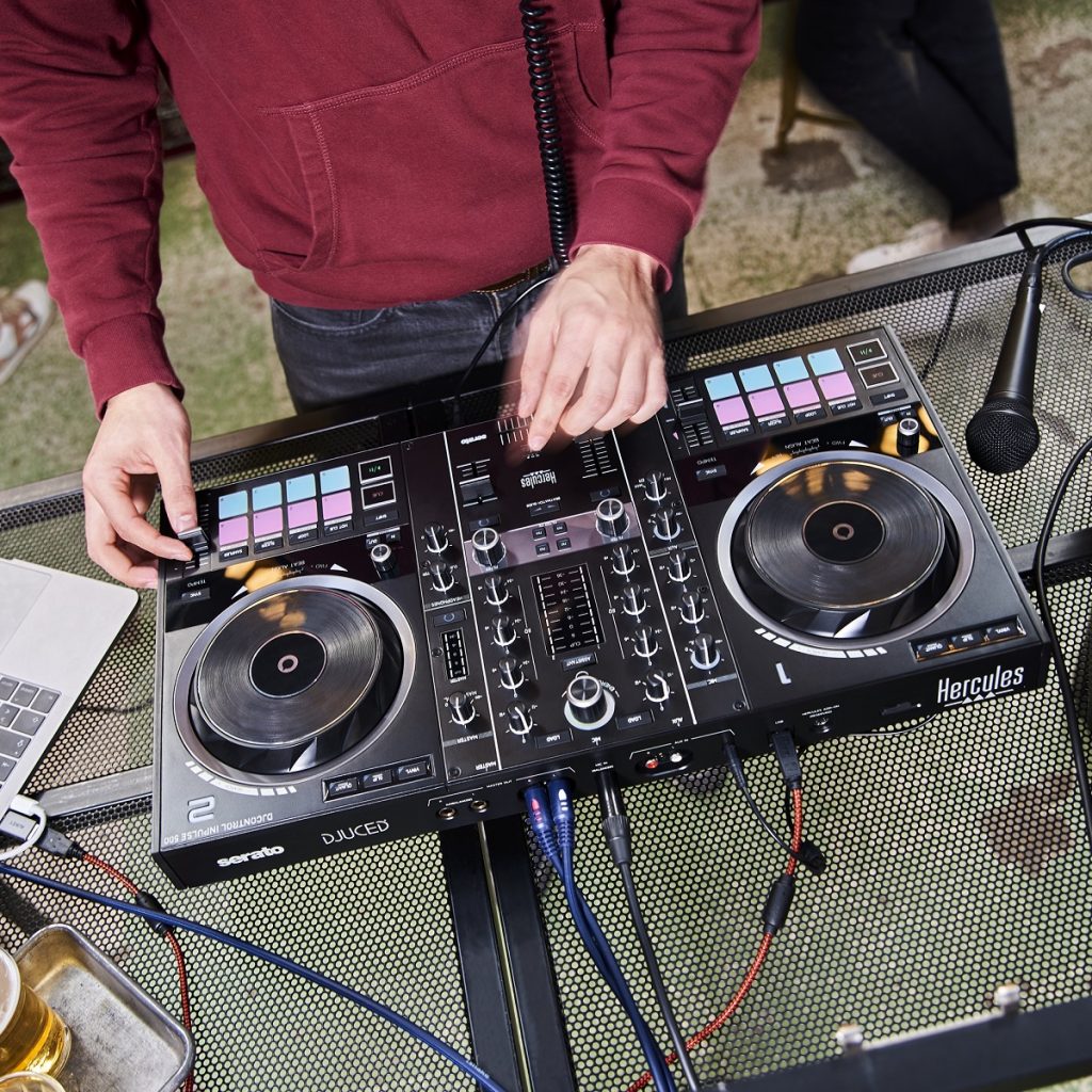 DJ using the Hercules DJControl Inpulse 500 DJ Controller outdoors
