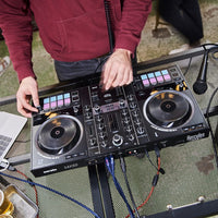 DJ using the Hercules DJControl Inpulse 500 DJ Controller outdoors