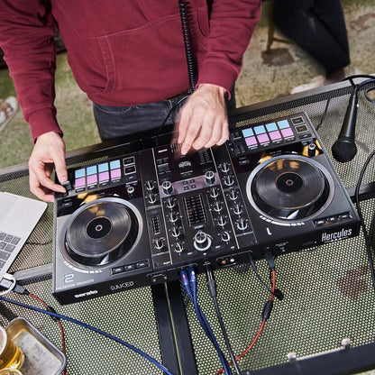 DJ using the Hercules DJControl Inpulse 500 DJ Controller outdoors